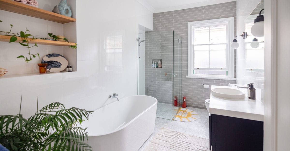 Bathroom remodel concept showing transition from renovation blueprint to finished space with modern vanity and custom tile shower