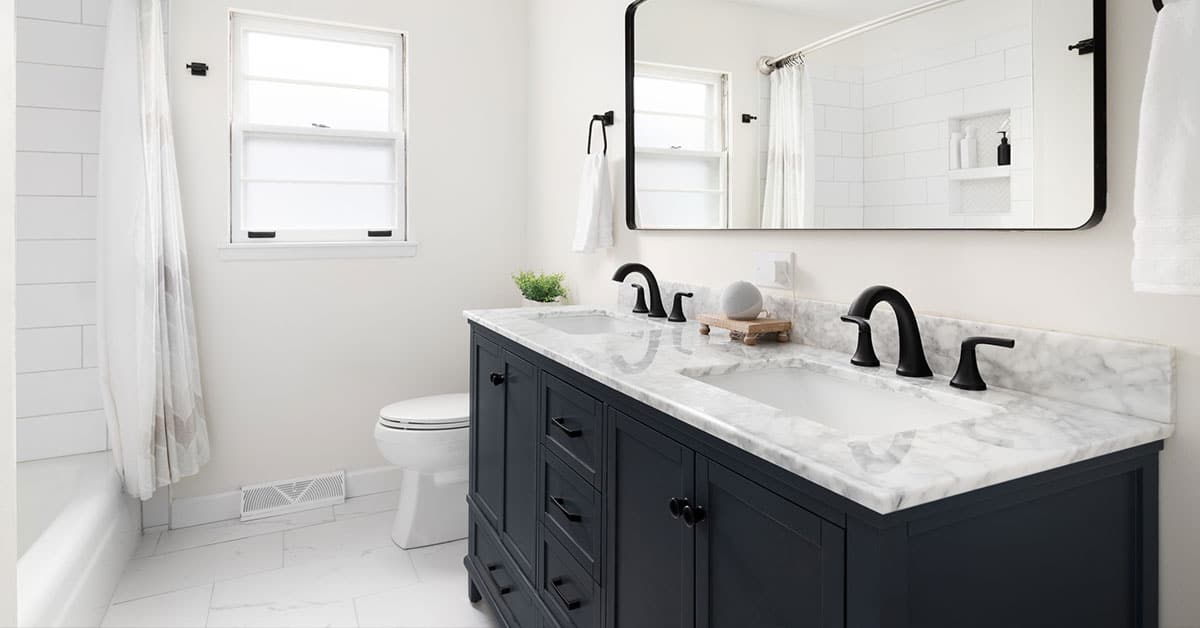 Questions-to-Ask-Potential-Contractors-2 Modern bathroom remodel featuring floating vanity, vessel sink, glass shower, and neutral tile flooring